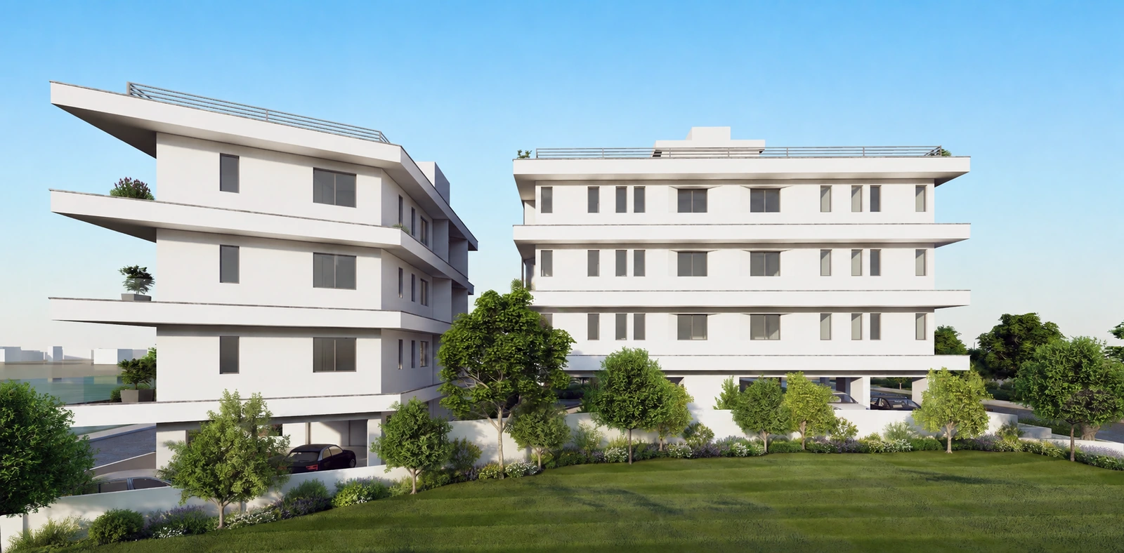 Zwei weiße Neubau-Residenzen mit Grünanlage